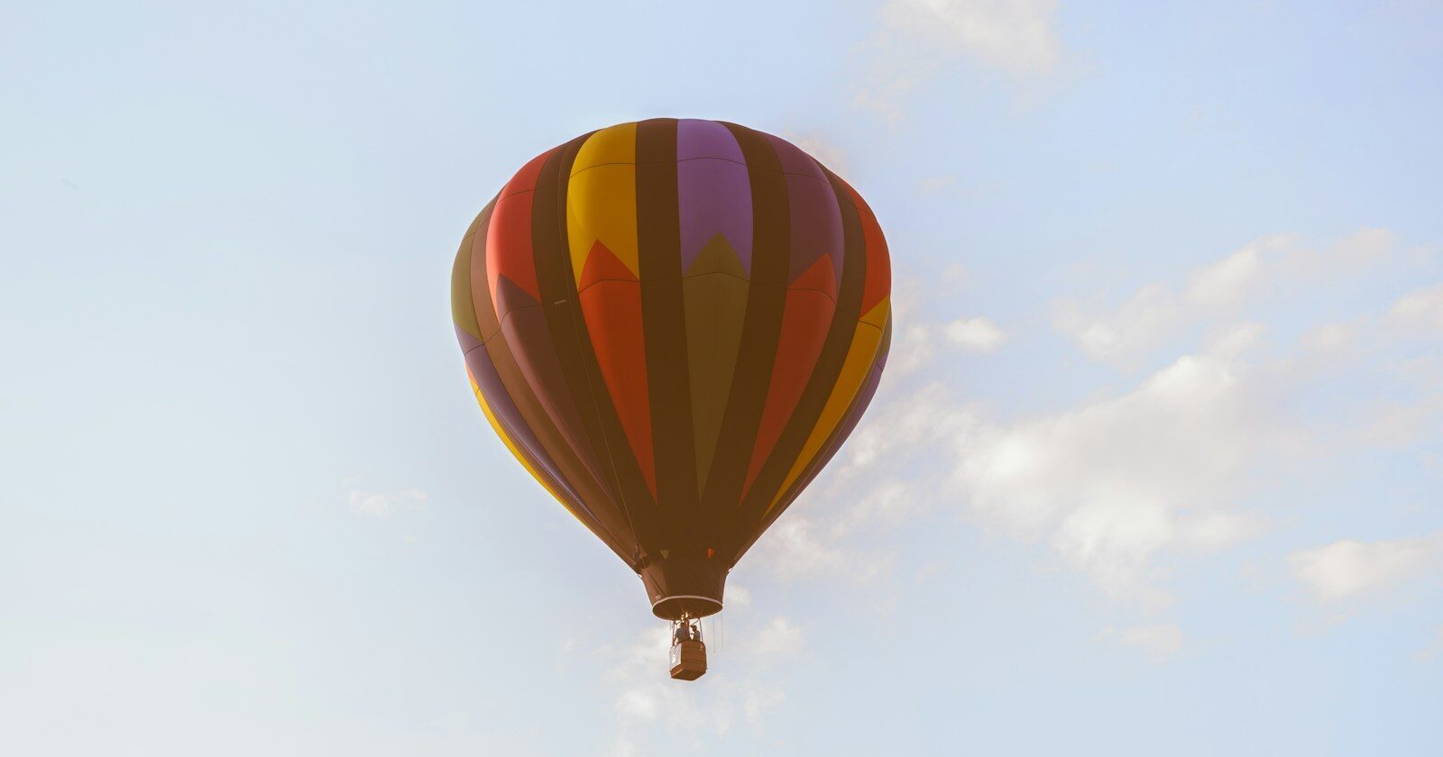 low angle photo of red and black hot air ballon